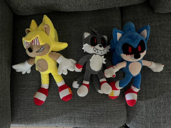 Three Sonic.exe themed plush toys.